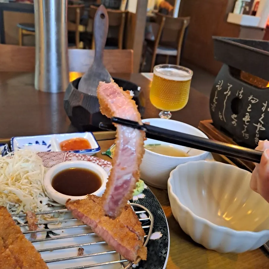 A piece of tenderloin gyukatsu dipped in the special sauce