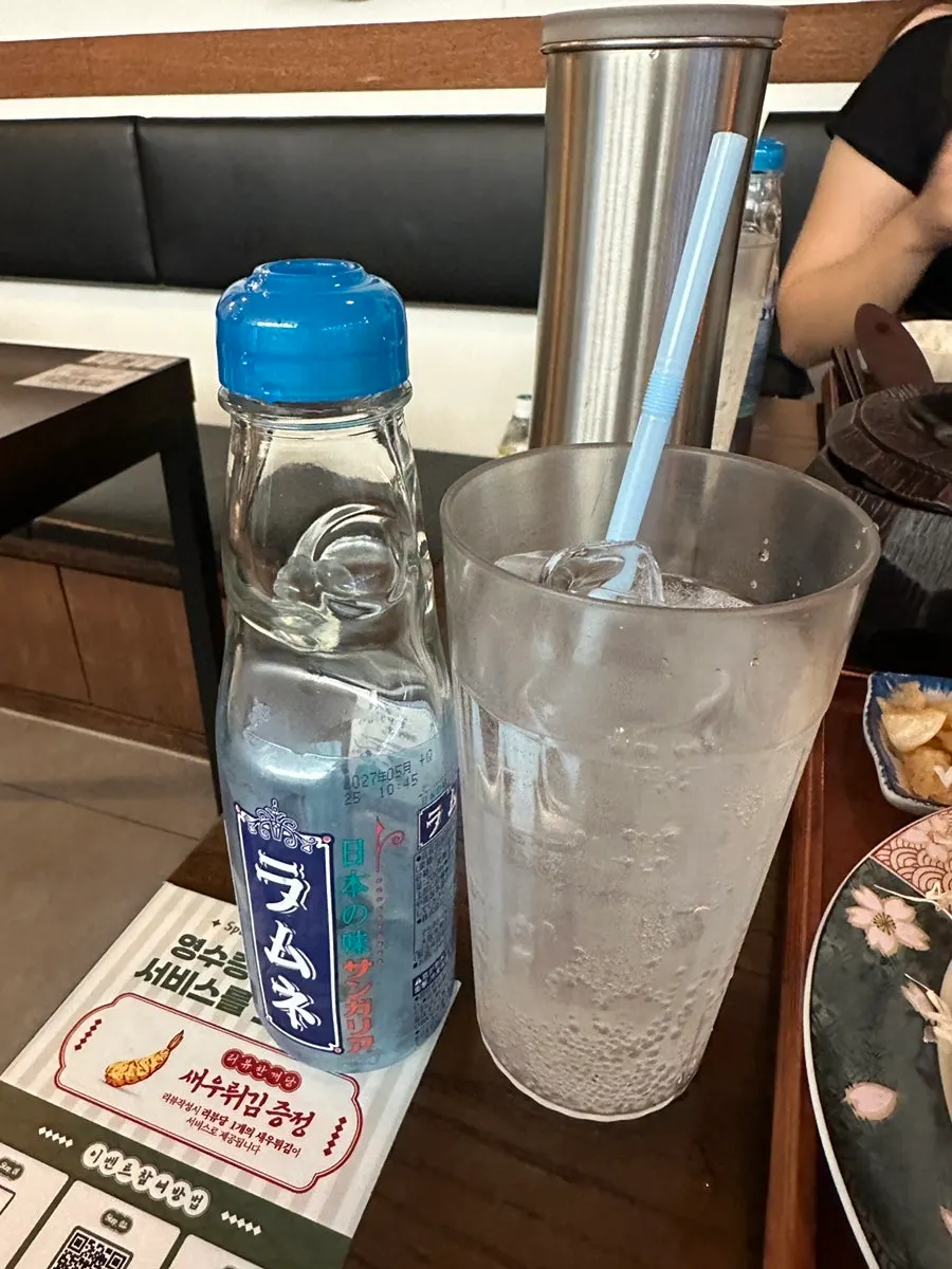 Ramune cider served with a cup of ice