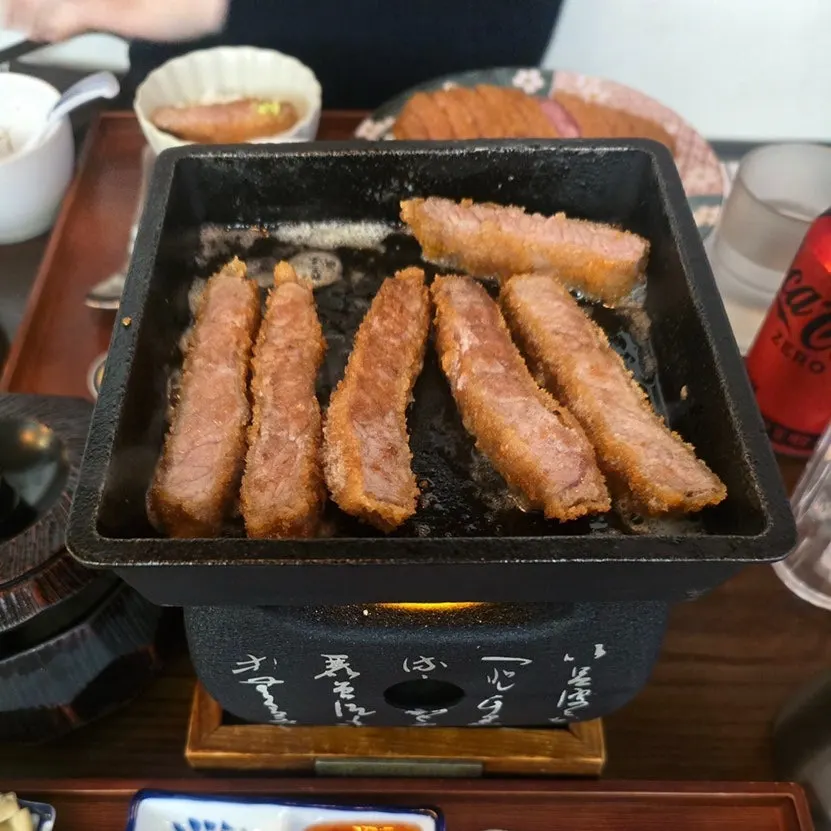 A piece of gyukatsu topped with salt and wasabi