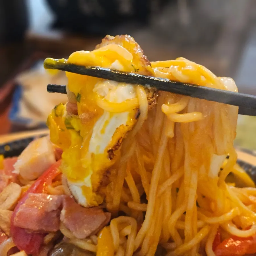 Napolitan noodles lifted up together with sausage