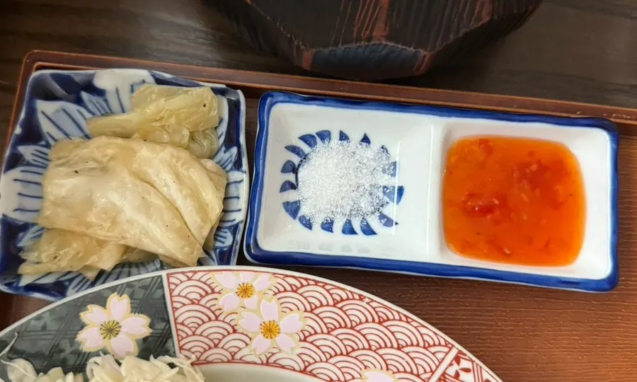 White kimchi with salt, chili sauce, soy sauce, and wasabi