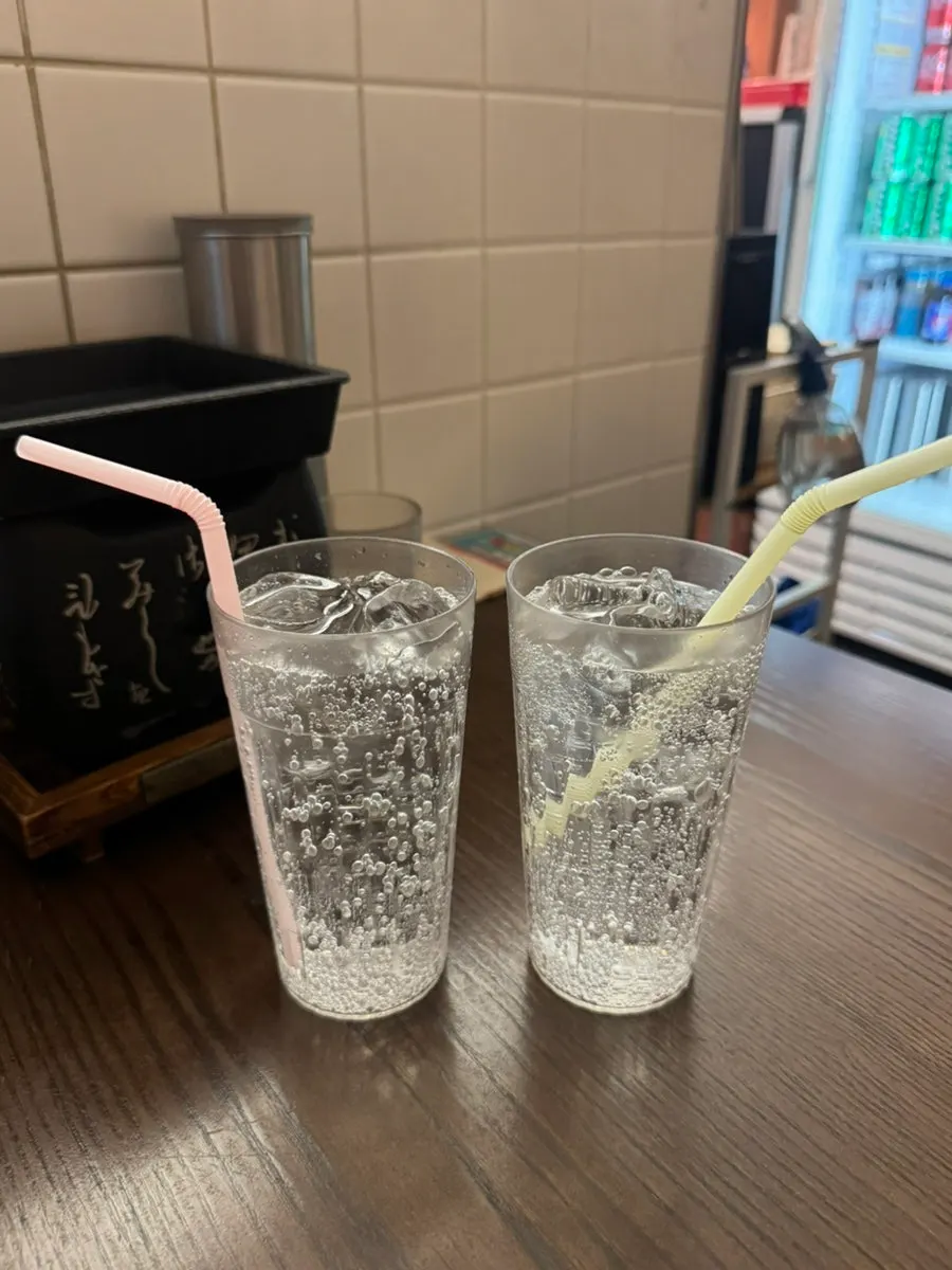 A cup of ice served alongside a drink