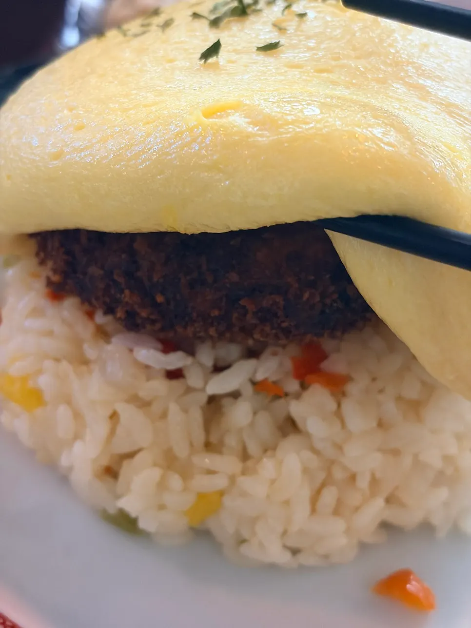 Hamburg steak revealed inside the sliced omurice