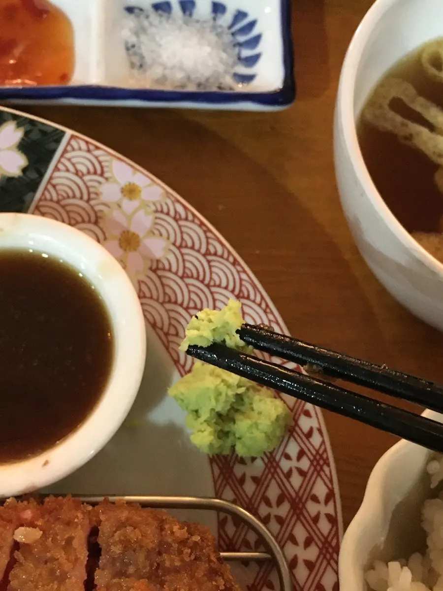 A piece of gyukatsu dipped in sauce