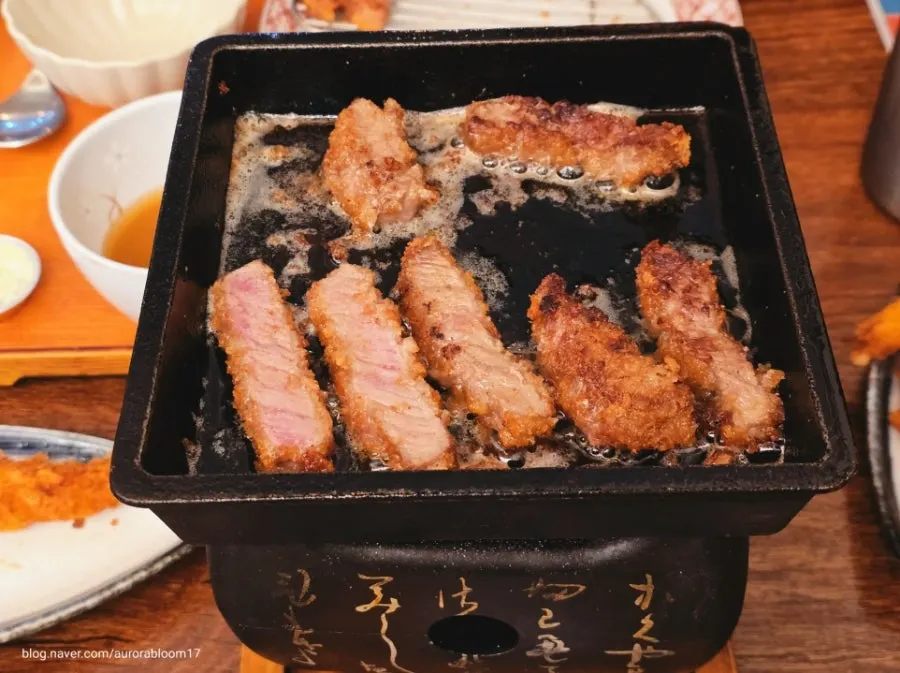 Well-marbled gyukatsu grilling on the brazier