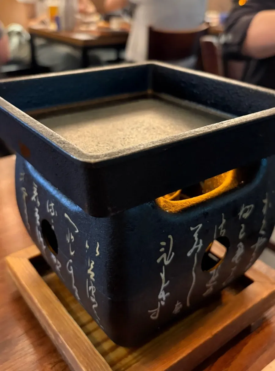 Japanese lettering stamped on the bottom of the brazier
