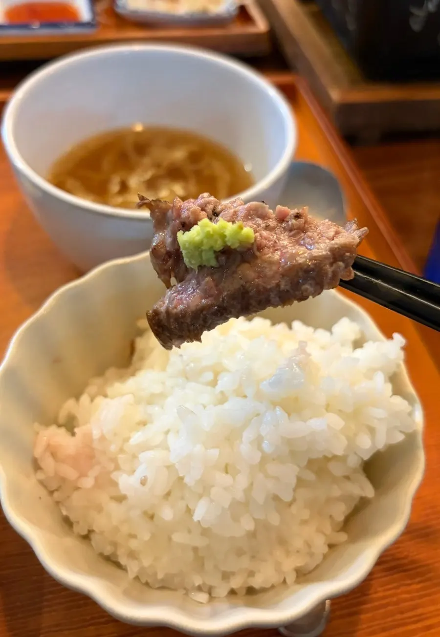 A piece of gyukatsu dipped in sauce