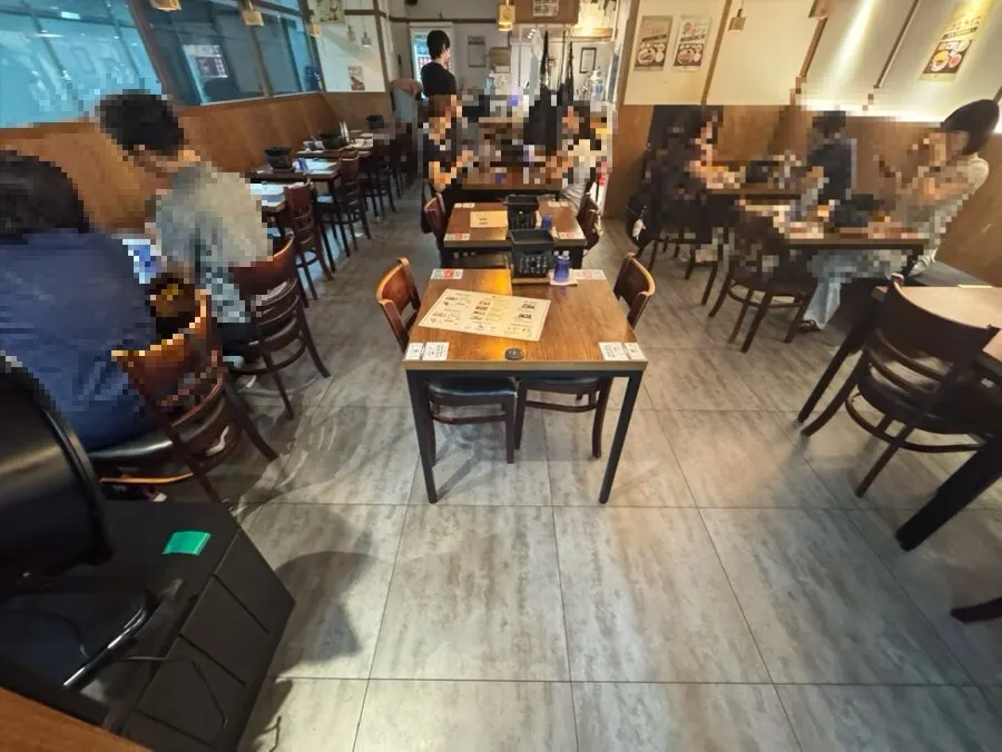 Interior of the restaurant with mostly two-person tables