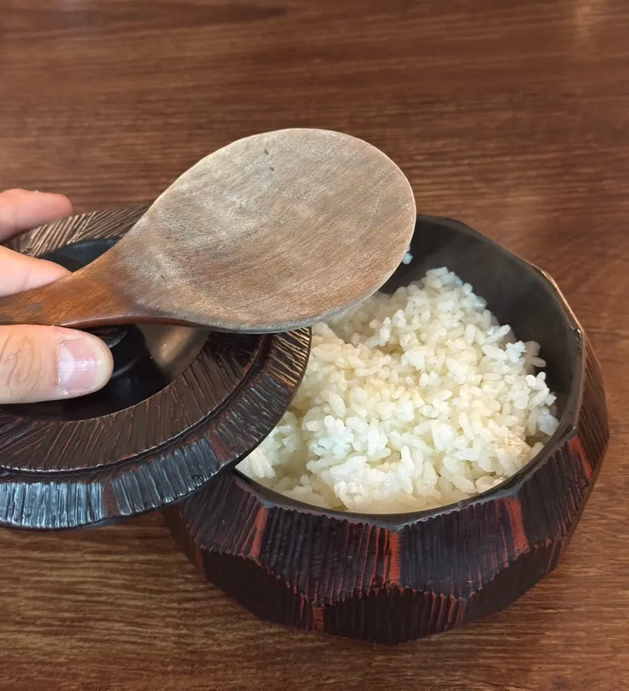 A generously filled bowl of rice served at the table