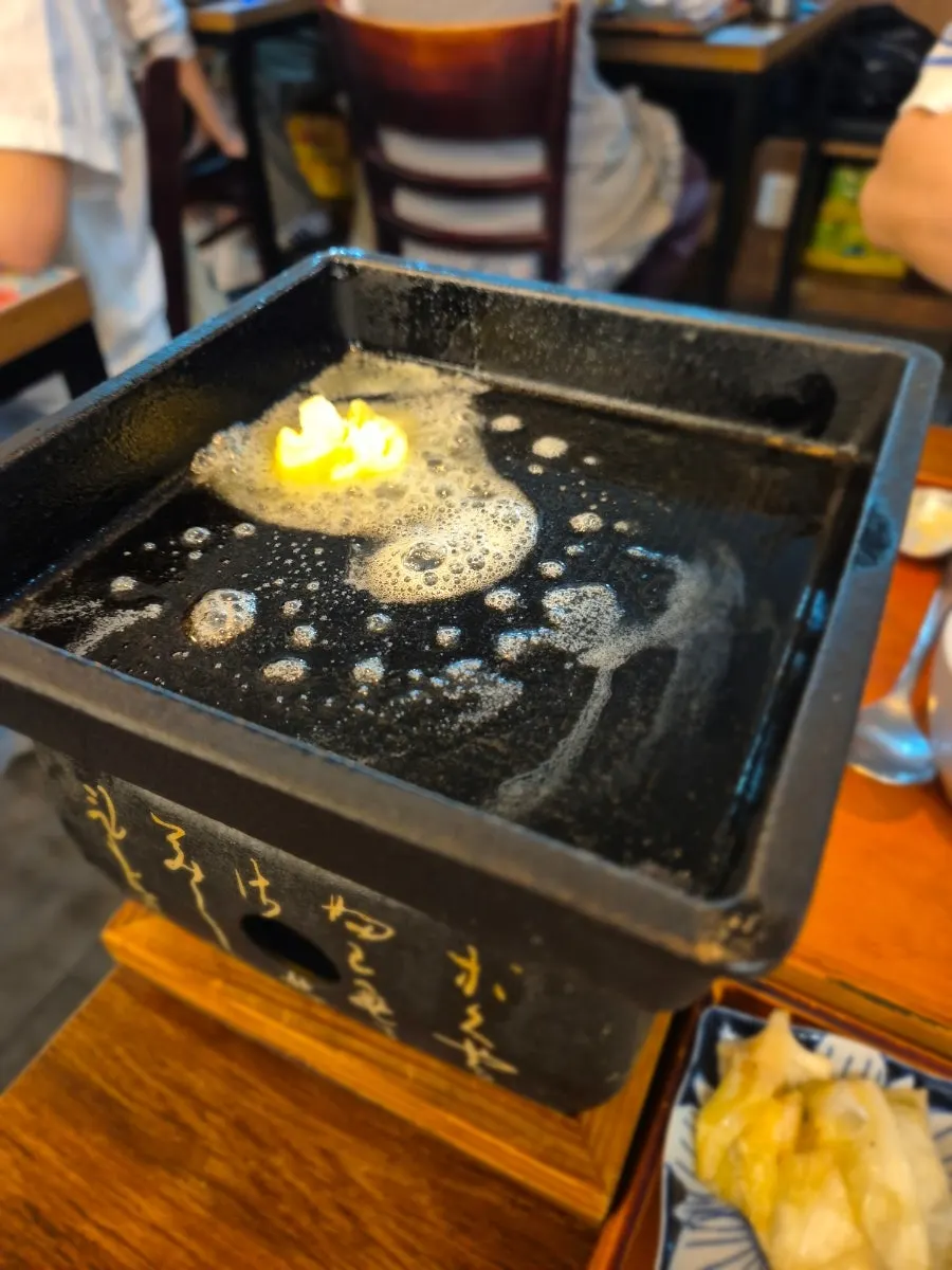 Gyukatsu grilling on the brazier with butter on top