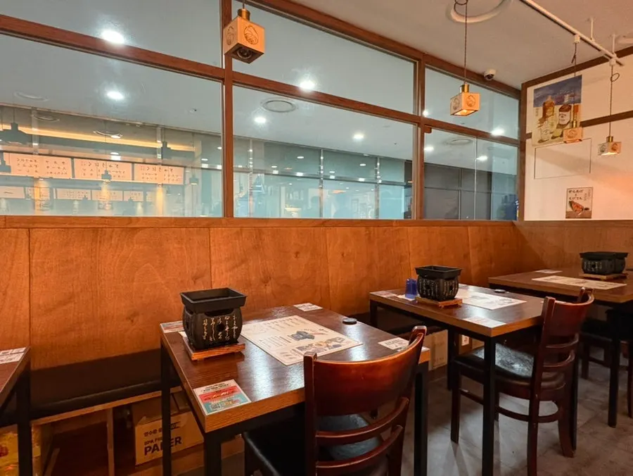 Interior of the restaurant with reddish wood-toned Japanese-style decor