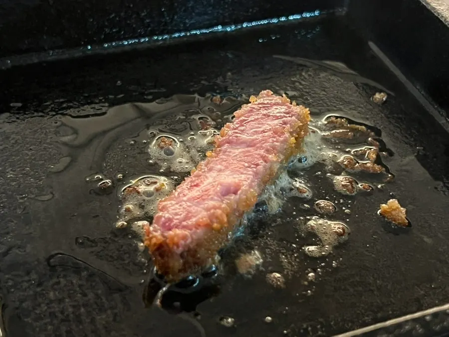 Gyukatsu with crispy breading contrasting the red interior