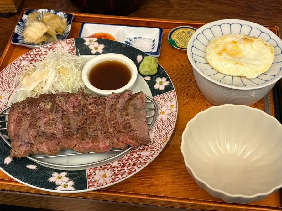 Table with two sirloin set meals and side dishes