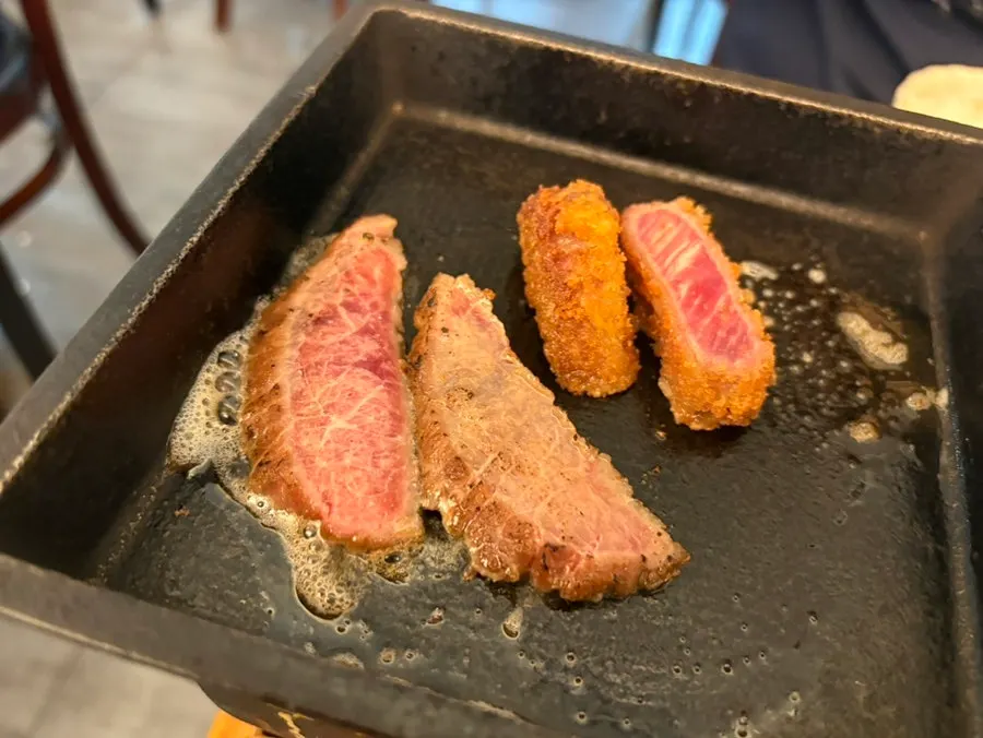 A piece of gyukatsu being grilled on top of the butter