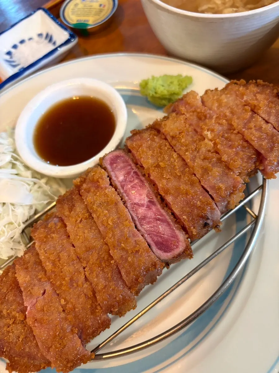 A bite of steki eaten with rice