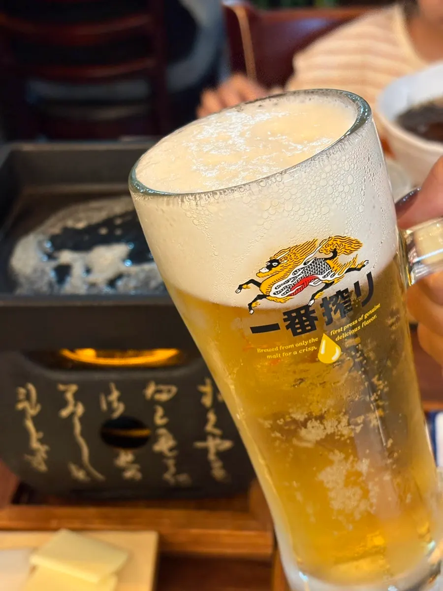 A glass of Kirin draft beer next to the steki