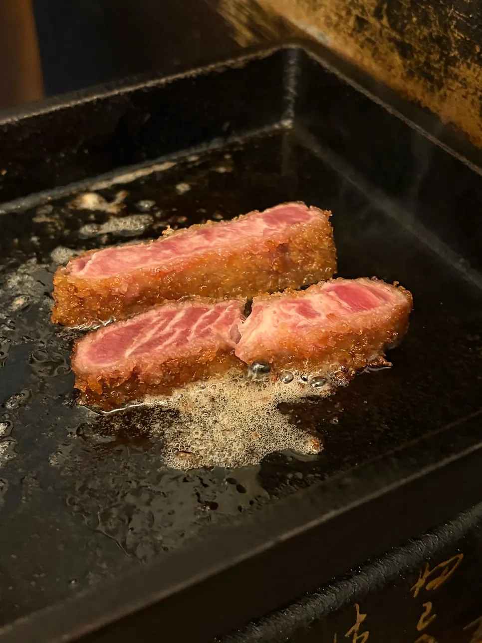 Grilling gyukatsu with butter on the tabletop grill
