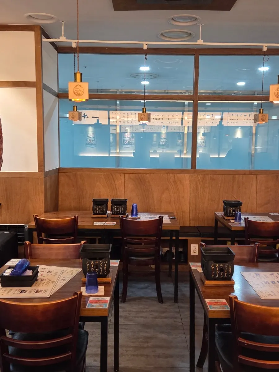 Interior of Ichigyu Seoul Station Branch with wood decor