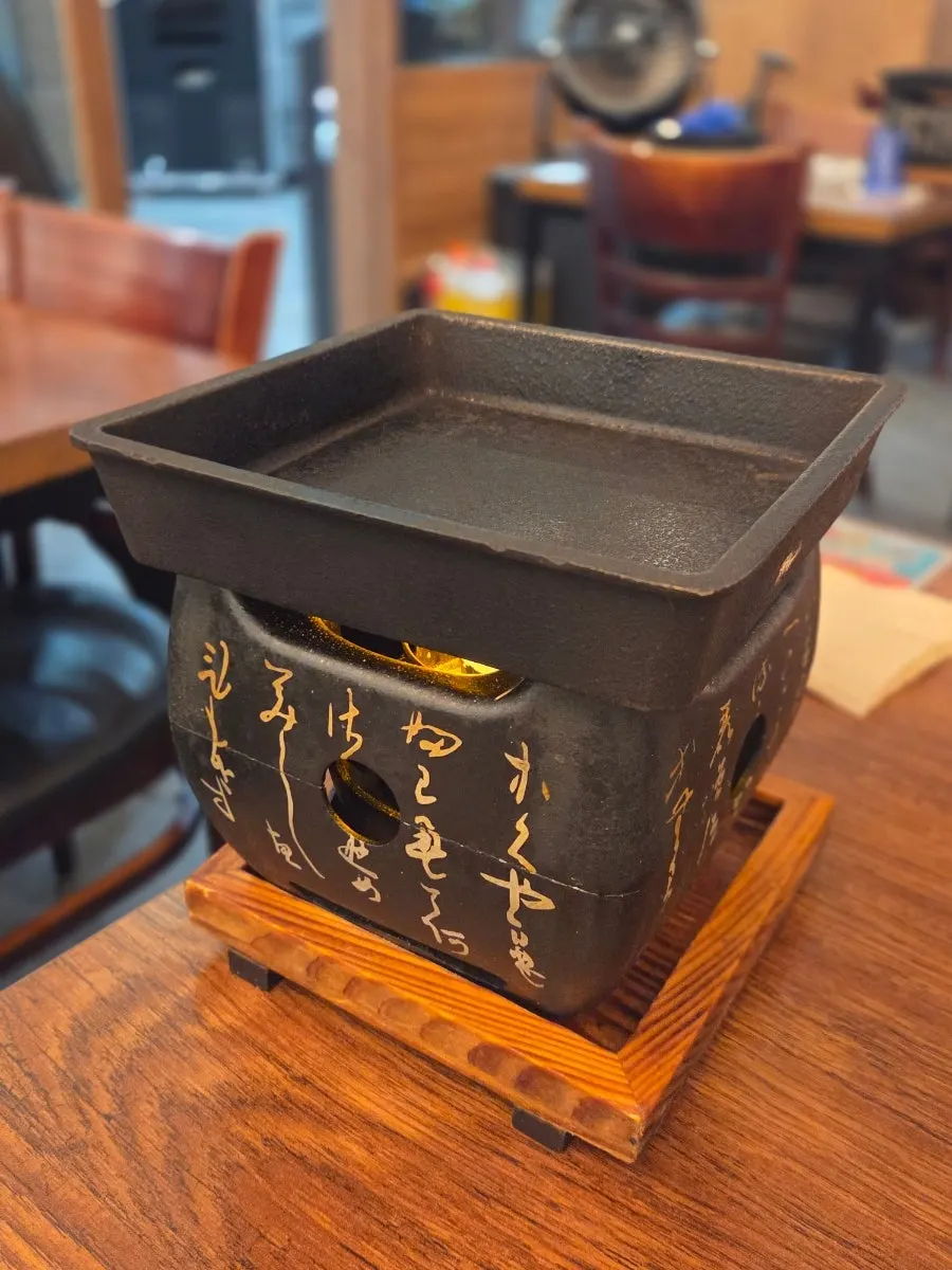 Square bowl-shaped brazier set on the table