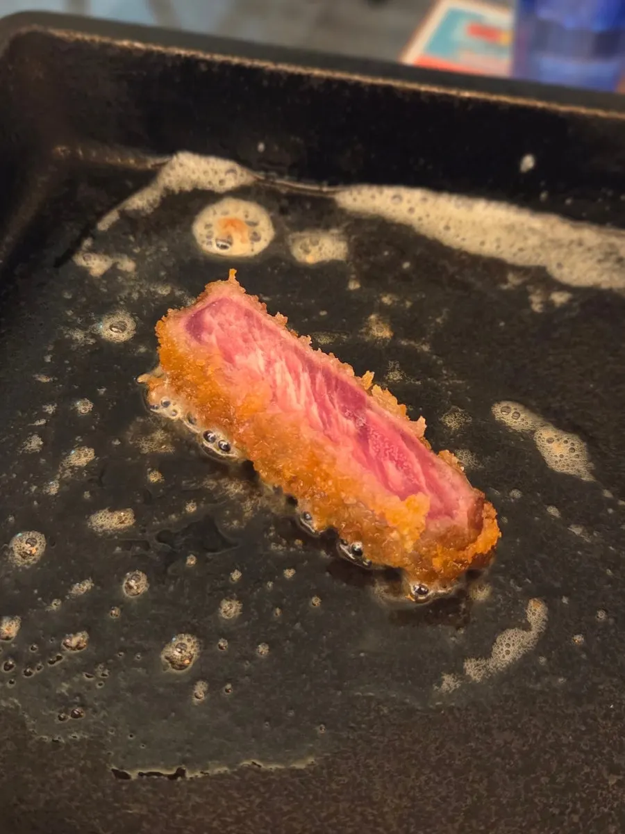 Placing gyukatsu on top of melted butter