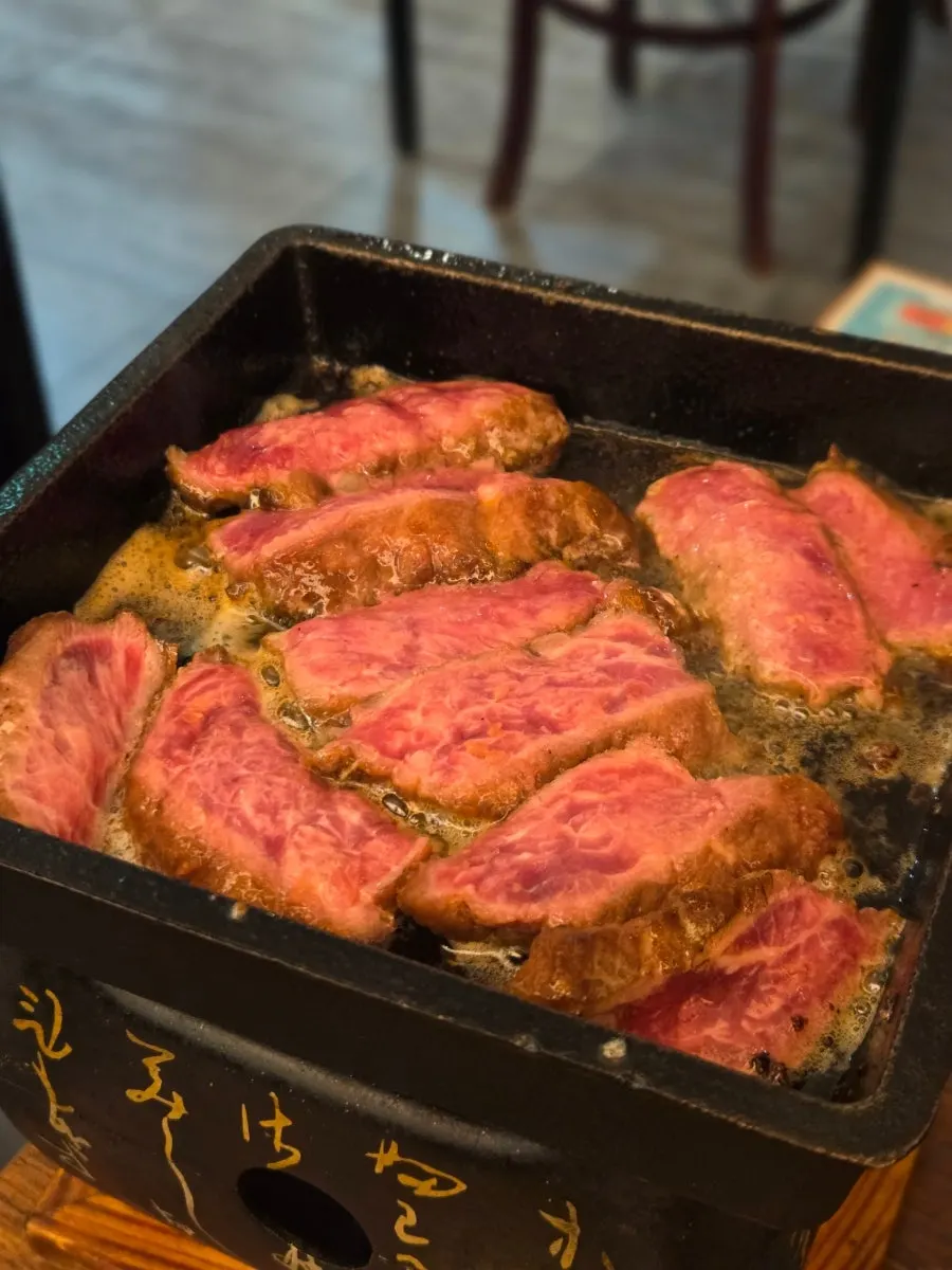 Sirloin from the steki set cooking on the brazier