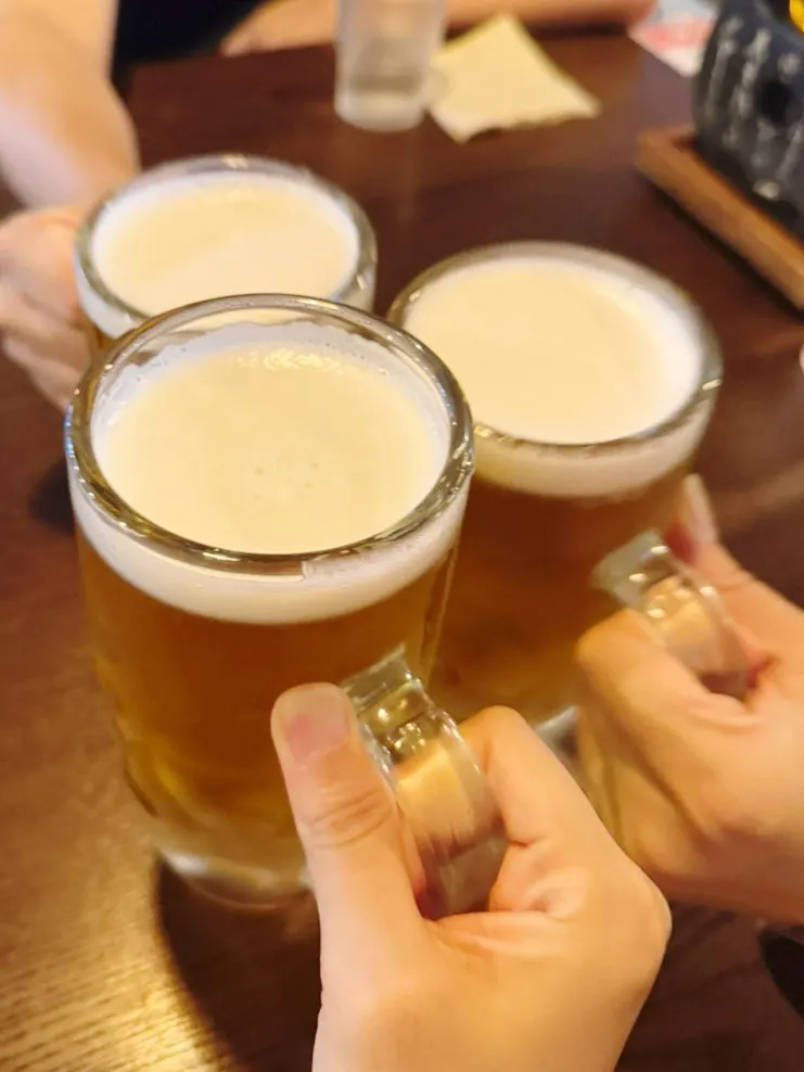 Toasting with three glasses of Kirin draft beer