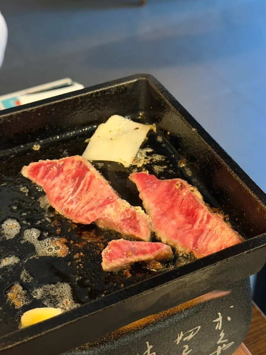 A piece of gyukatsu topped with melted cheese