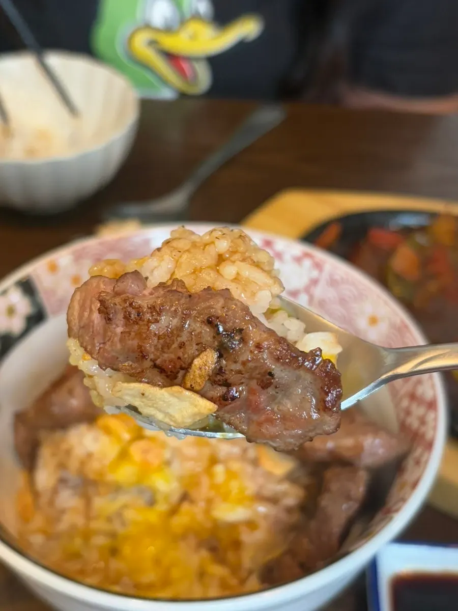 Grilled sirloin steak placed over rice