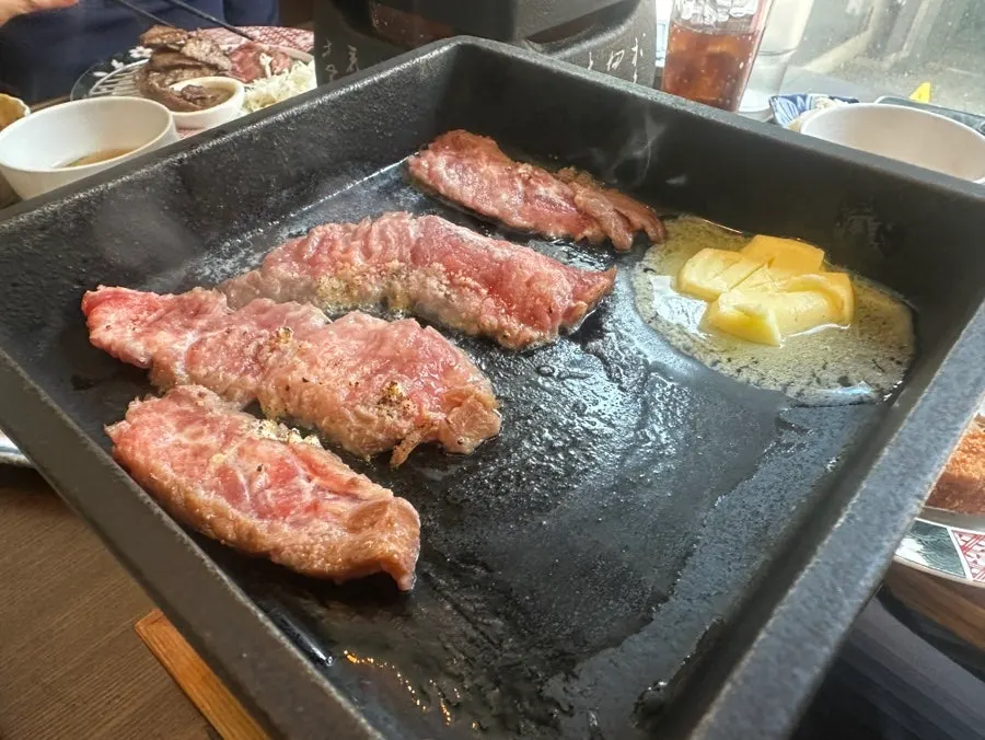 Steki meat placed on the butter-melted grill