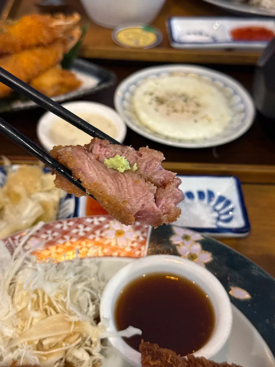 A piece of gyukatsu placed on rice