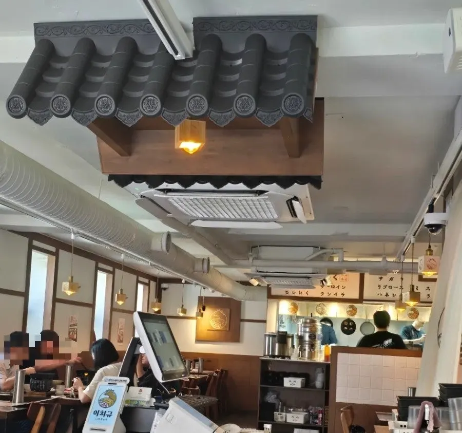 Dining hall decorated with wood interiors and Japanese vintage posters
