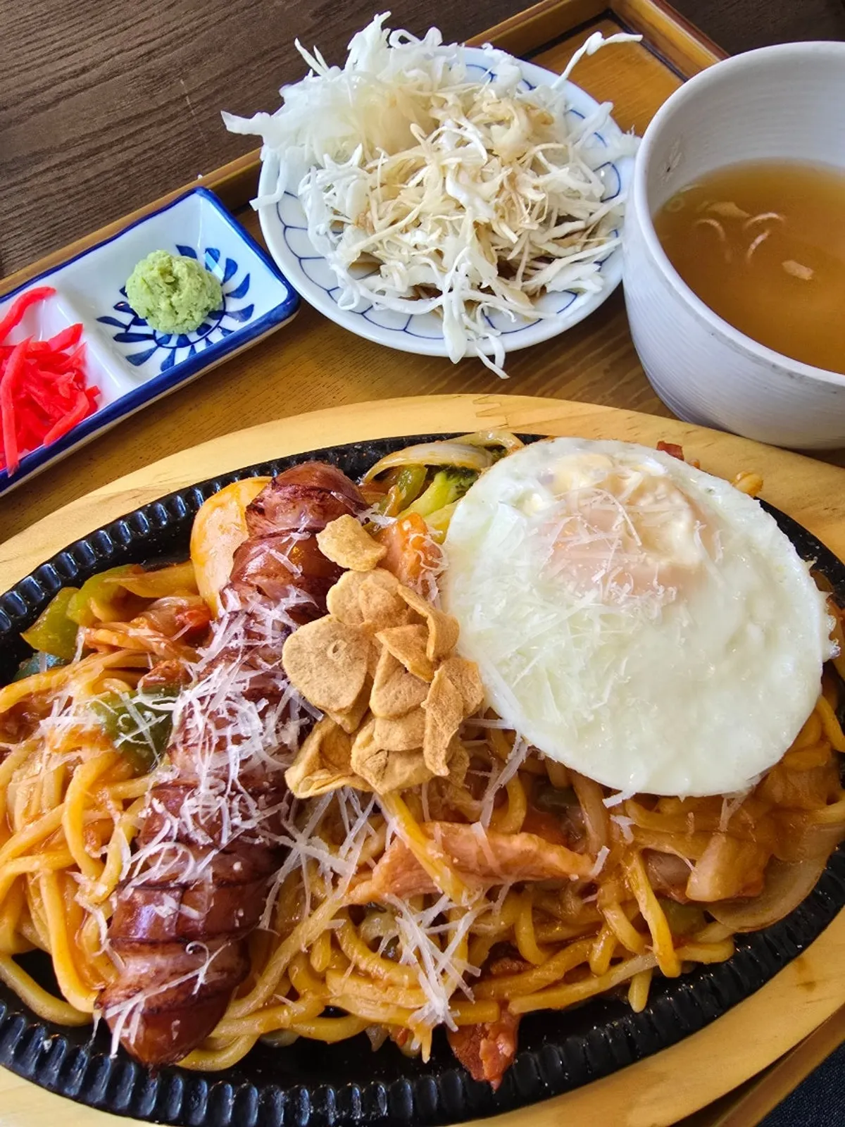 Yakisoba Napolitan on a hot plate with a soft-boiled fried egg