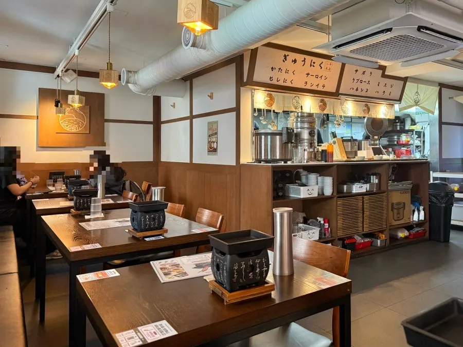 Interior of Ichigyu Gangnam Sinnonhyeon Branch with wood-toned decor