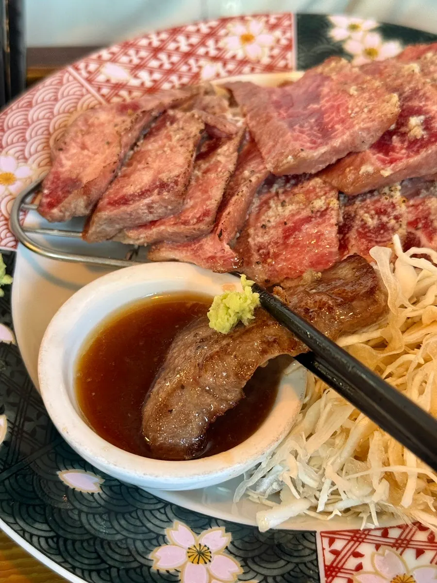 A piece of steki dipped in sauce