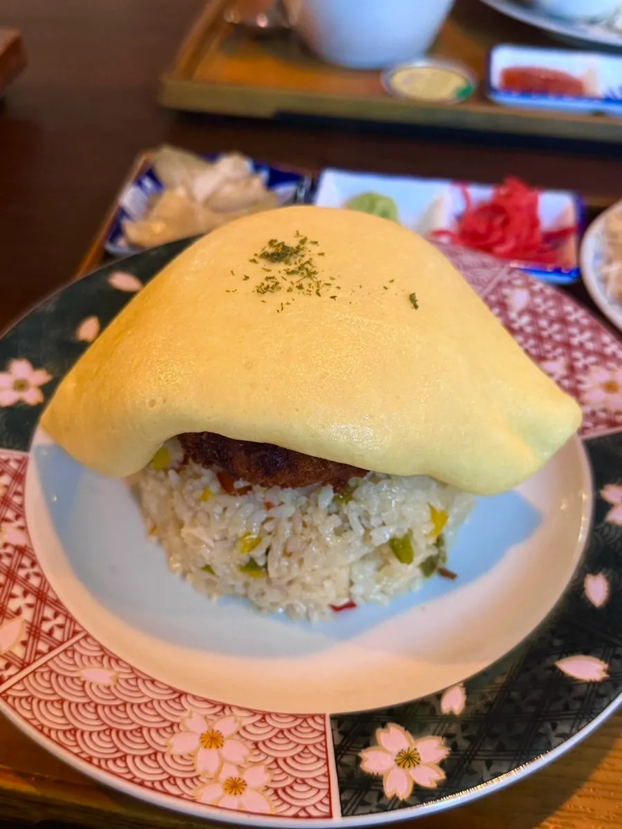 Fluffy omelet sitting on top of the rice