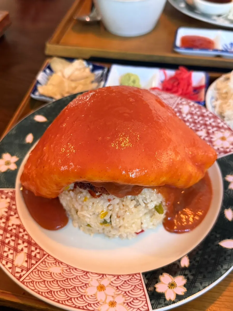 Brown sauce trickling down over the omurice