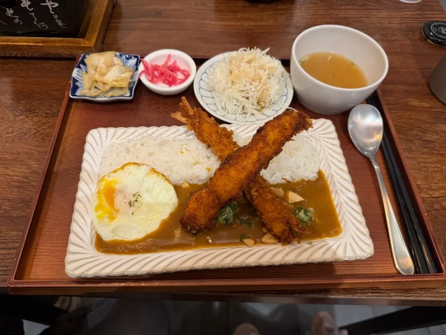 Japanese-style curry topped with shrimp tempura and a fried egg