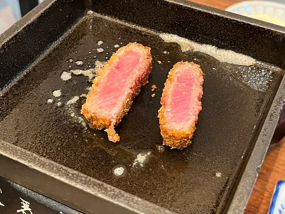 A piece of gyukatsu topped with salt and wasabi