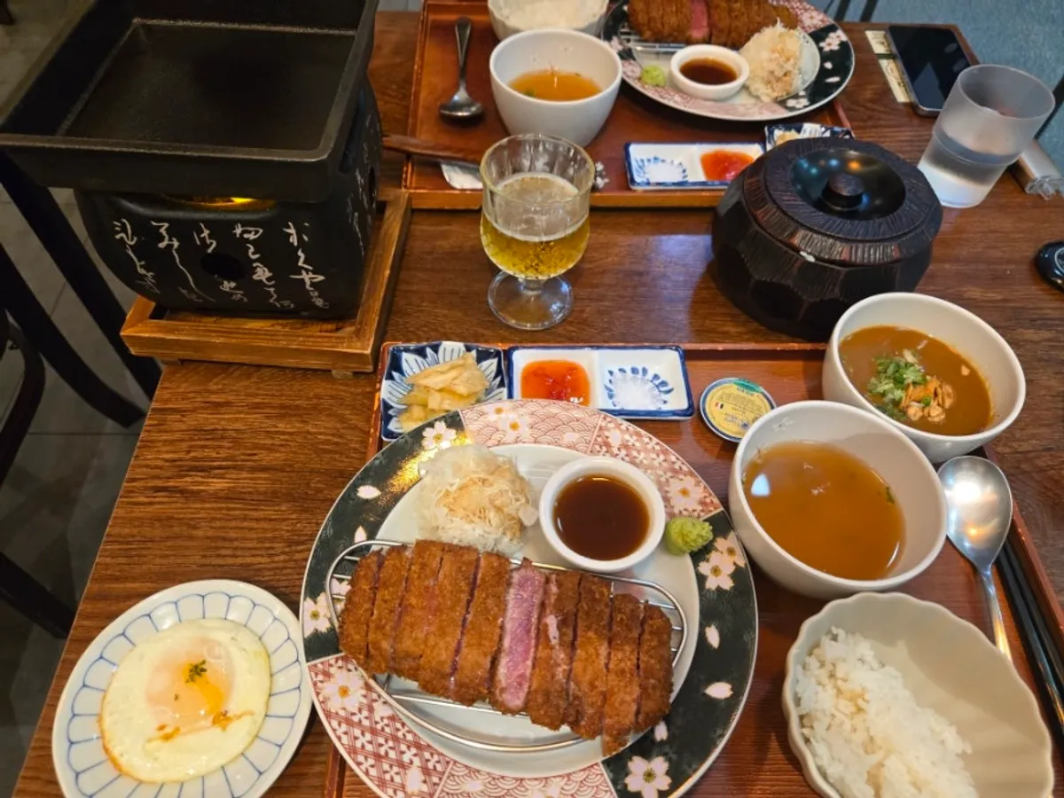 Full spread of gyukatsu sirloin, mini curry, and draft beer