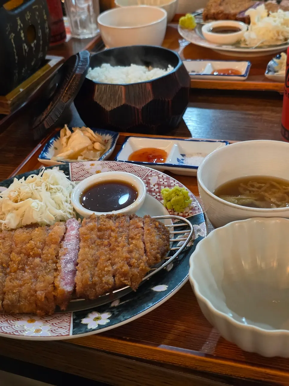 Set table with two gyukatsu meals and a drink included