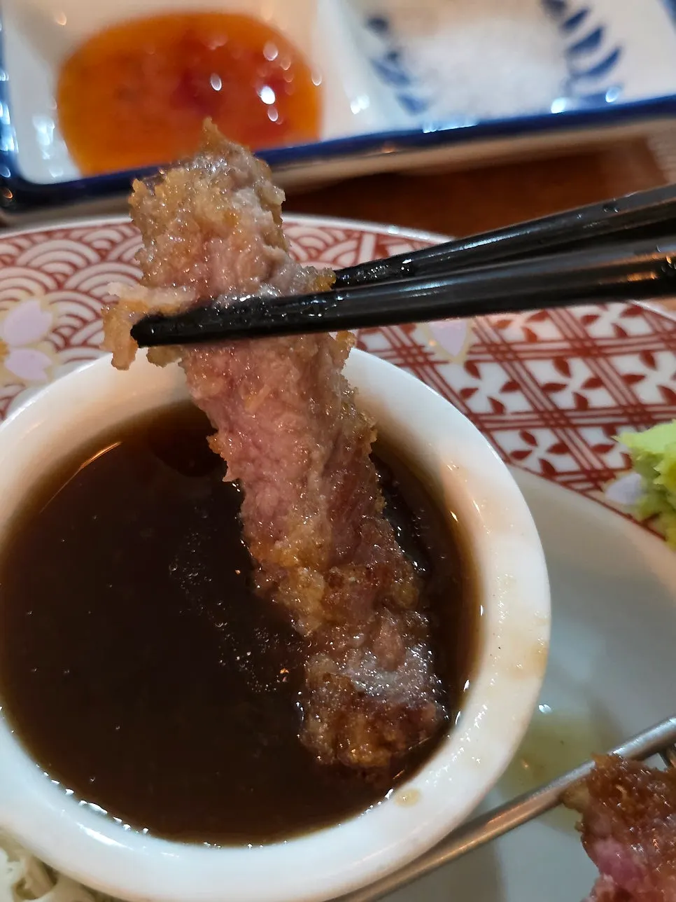 Dipping the gyukatsu into sauce