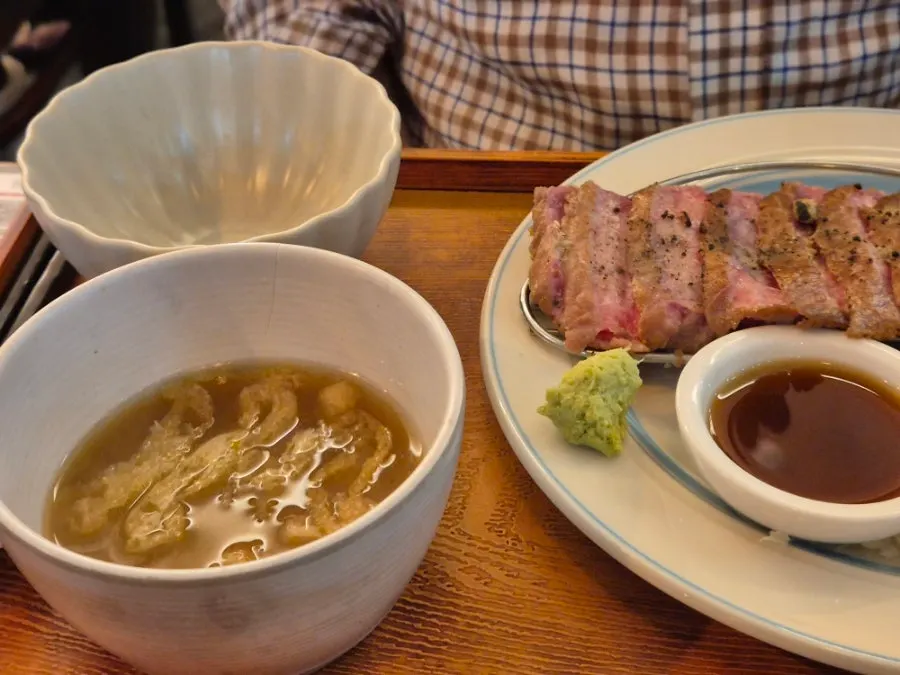 A meal of gyukatsu with rice and salad on the side