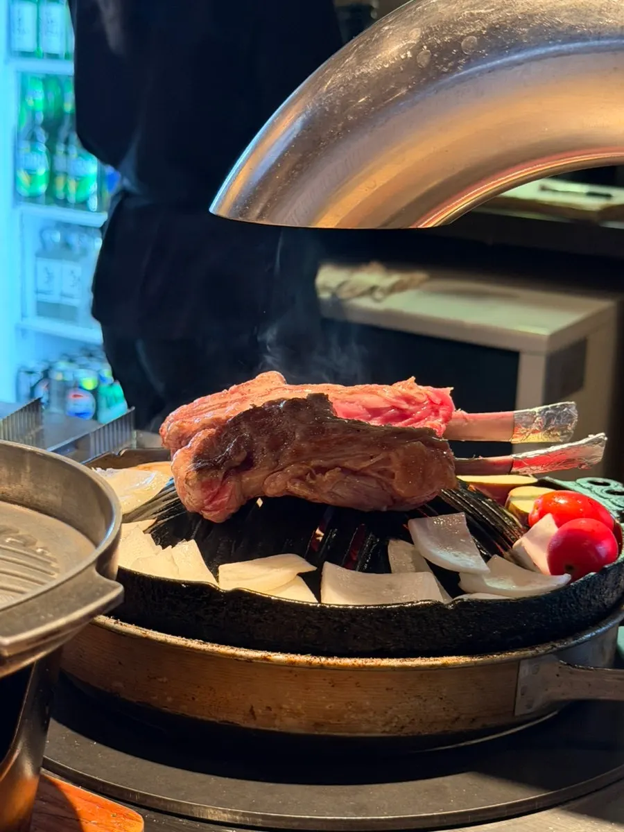 Onions, mushrooms, and eggplant grilling alongside the lamb