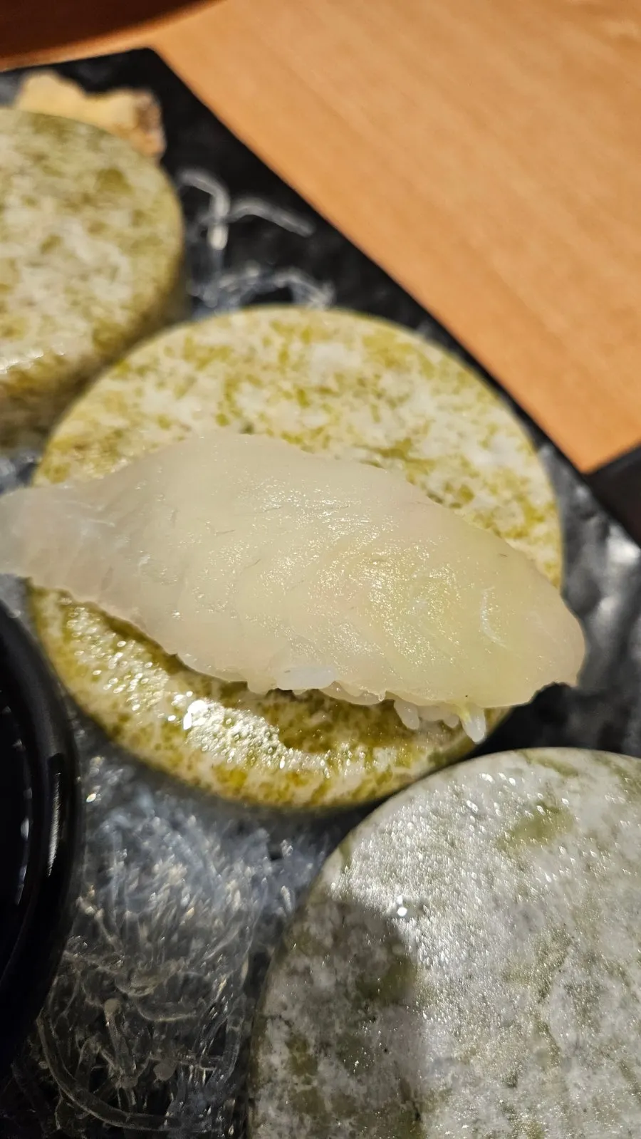 Flounder and salmon sashimi platter on a stone plate