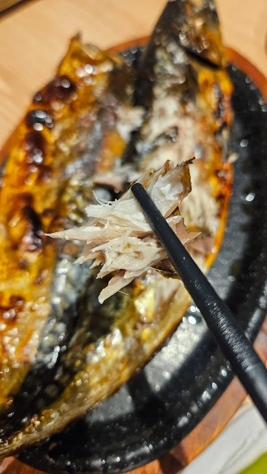 Golden-browned flesh of the grilled mackerel