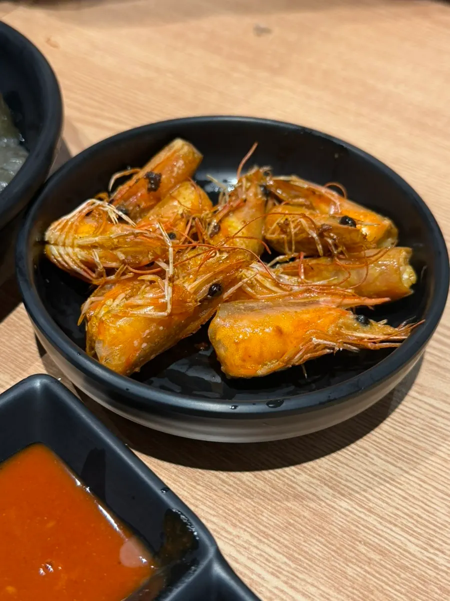 A plate of butter-grilled shrimp heads
