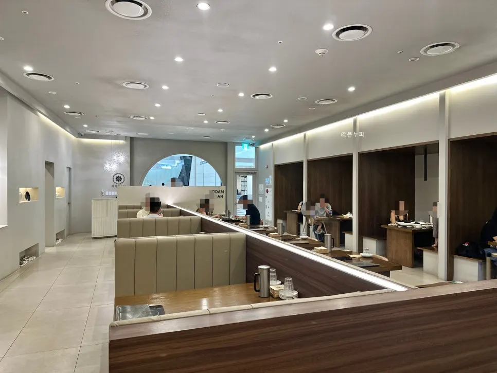 Wide, neatly arranged hall seating at Modam Urban
