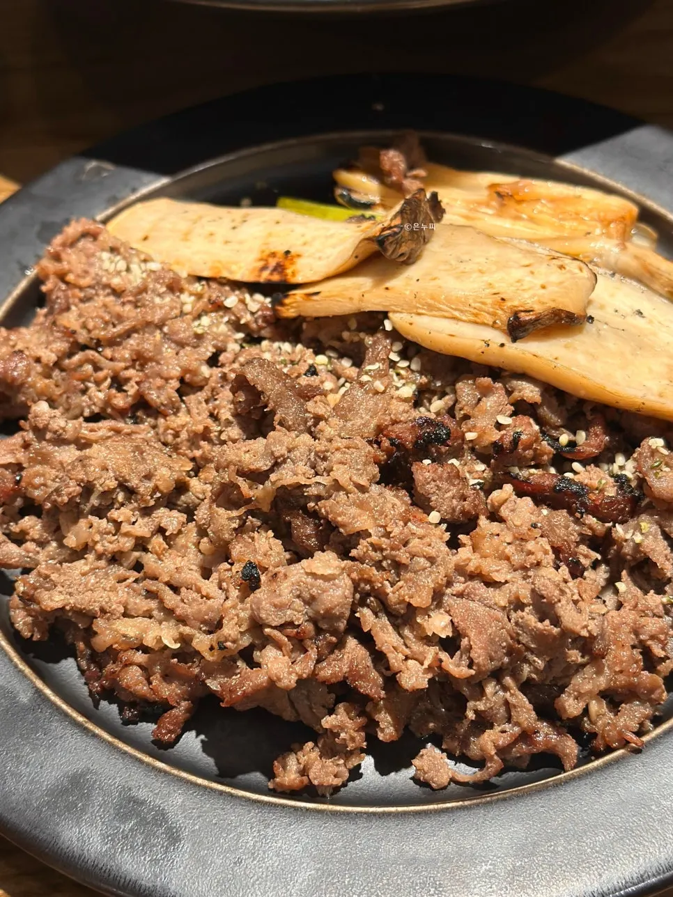 Bassak bulgogi served with grilled scallion and mushroom