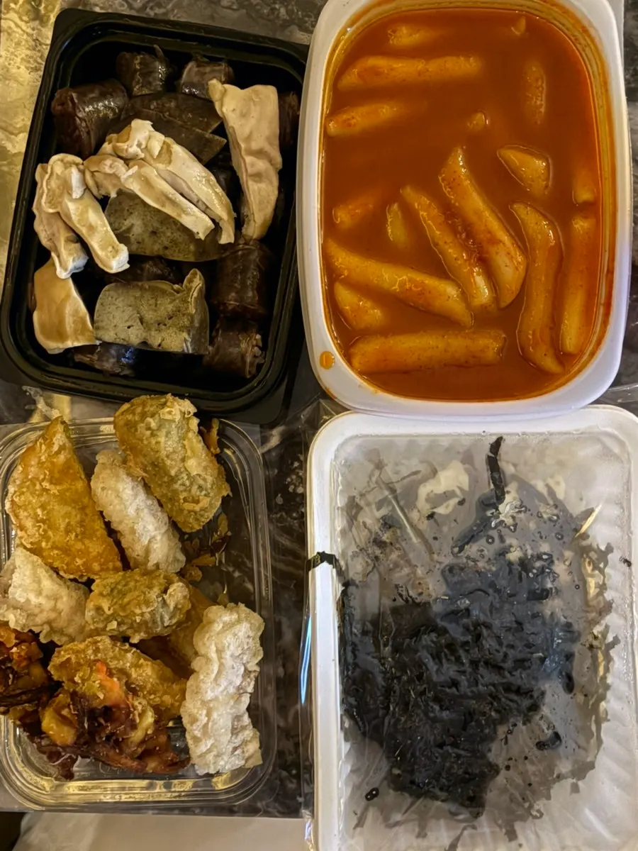 Rice cakes and fish cakes well coated in sauce