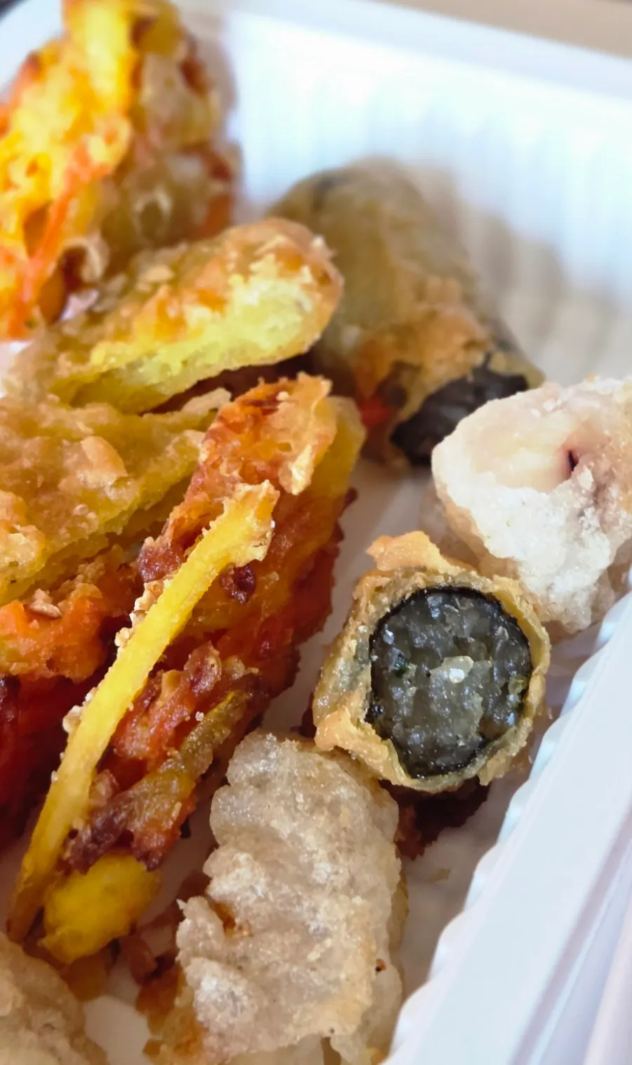 Assortment of kimmari, vegetable, sweet potato, squid, and dumpling fried snacks